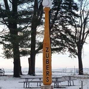 Winter scene of yellow baseball bat and baseball