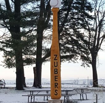 Winter scene of yellow baseball bat and baseball