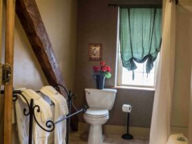 bathroom with large wood beam